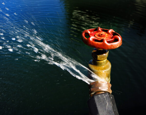 Detail of hose faucet connection leaking and squirting water spray